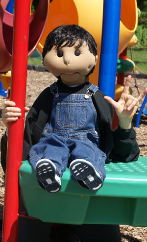 Jay the puppet, swinging on a tire swing.