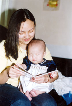 mother reading a book to her daughter