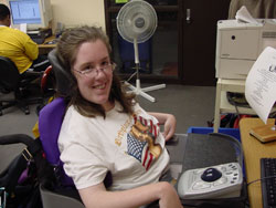 teen girl at a computer using assistive technology to access it